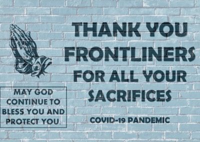 Text on brick wall that reads Thank You Frontliners with hands in prayer graphic